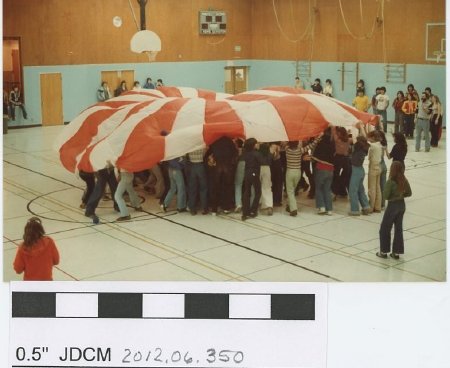 Children playing with a parachute indoors