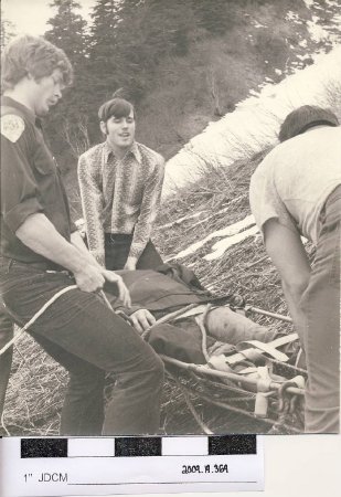B/W photo, three men and stretcher rescue, 1976