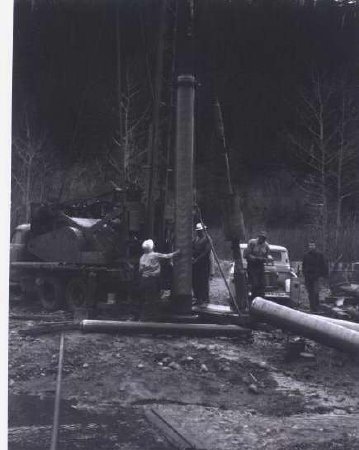 4 men working with pile driver