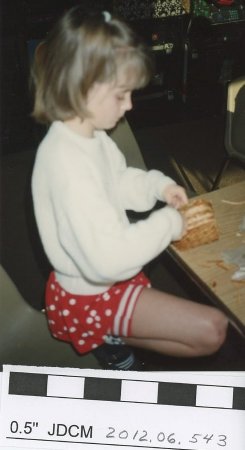 Child weaving a basket