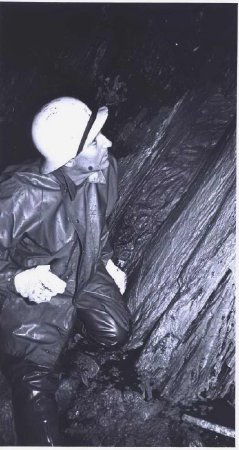 man underground examining rock