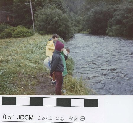 Children standing on a river bank